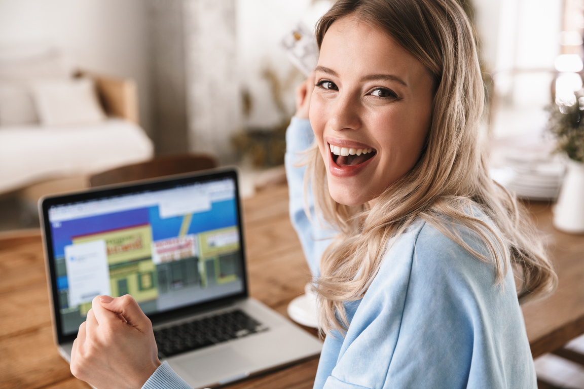 Blond Woman Using Laptop and Credit Card